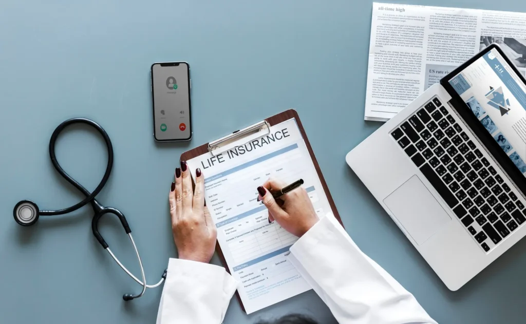 Doctor filling out life insurance form
