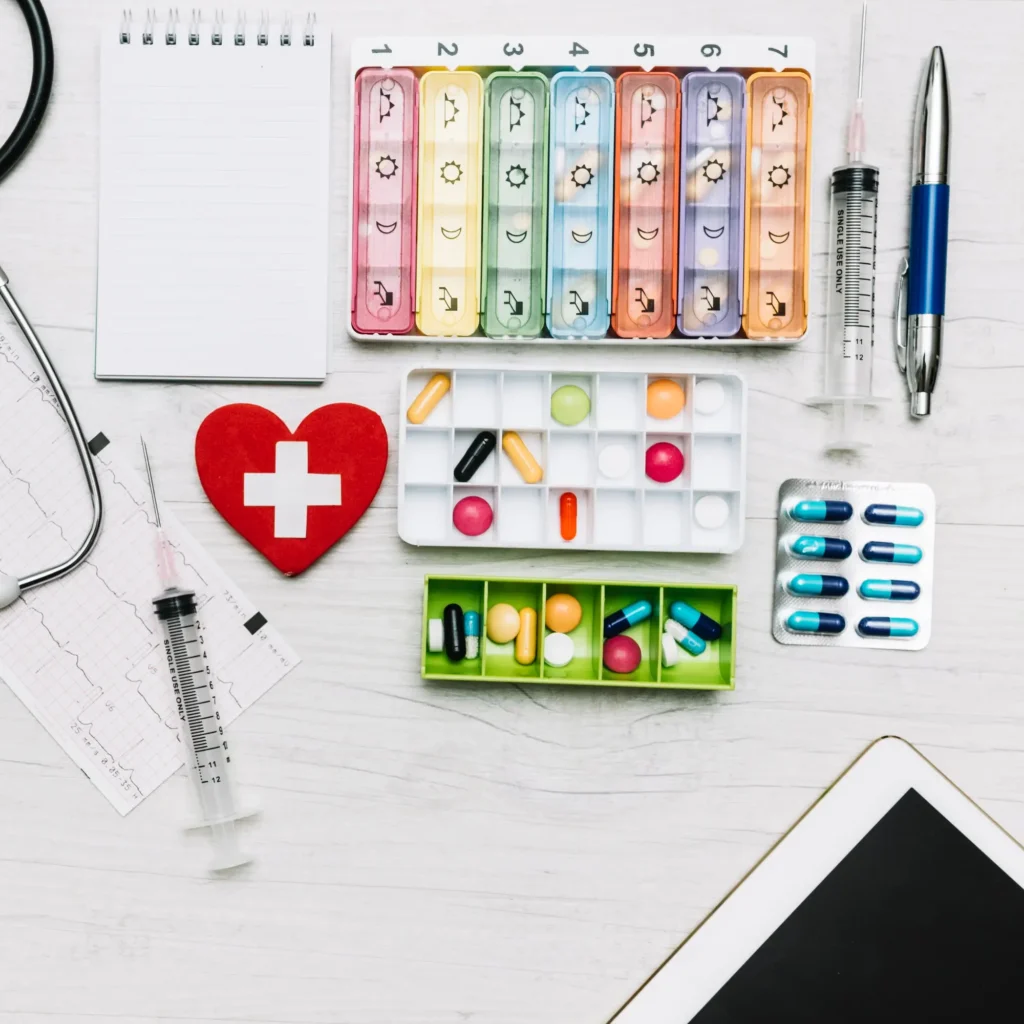 Medication boxes and a notebook on a table, hidden in a conference room.